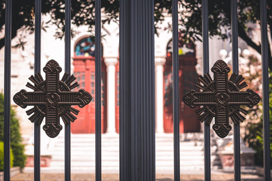 Close-up of an ornamental metal gate with decorative scrollwork.